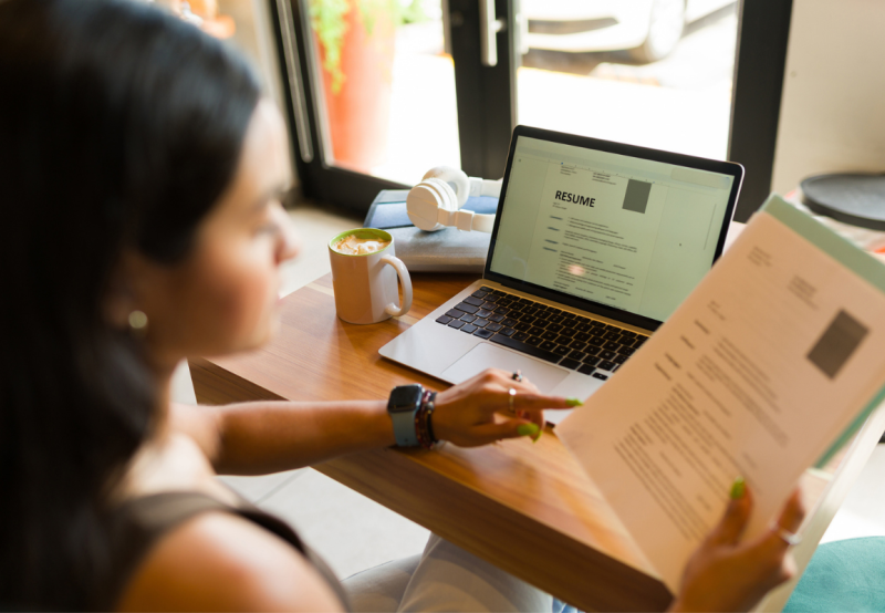 Woman reviews resume before applying for a job; part of her candidate experience.